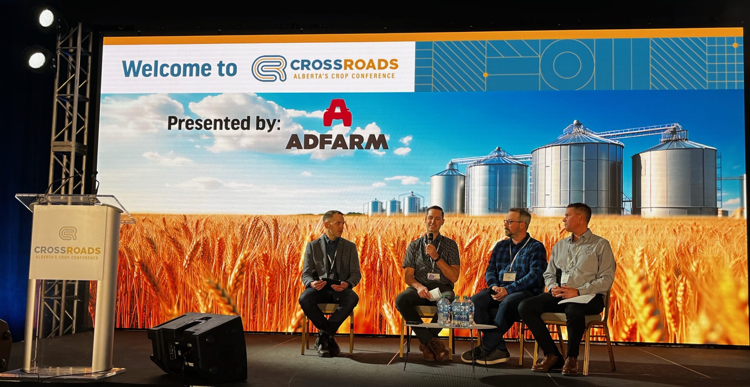 Panel of four men speaking at Crossroads Crop Conference